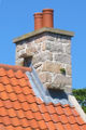 Witches' stones on tiled roof Jersey.jpg